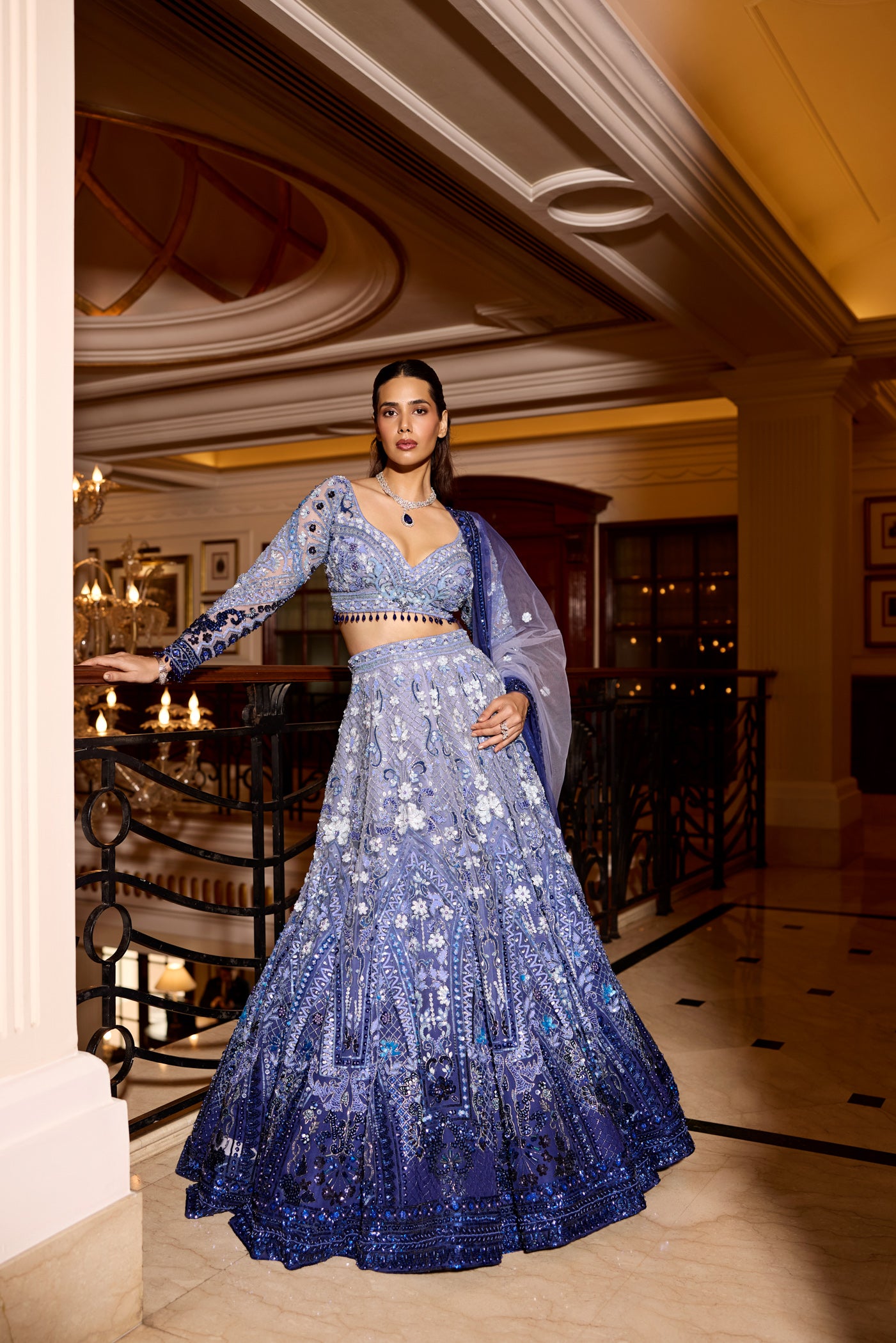 Designer blue ombre lehenga with mirror work, sequins, and floral detailing for luxury bridal wear