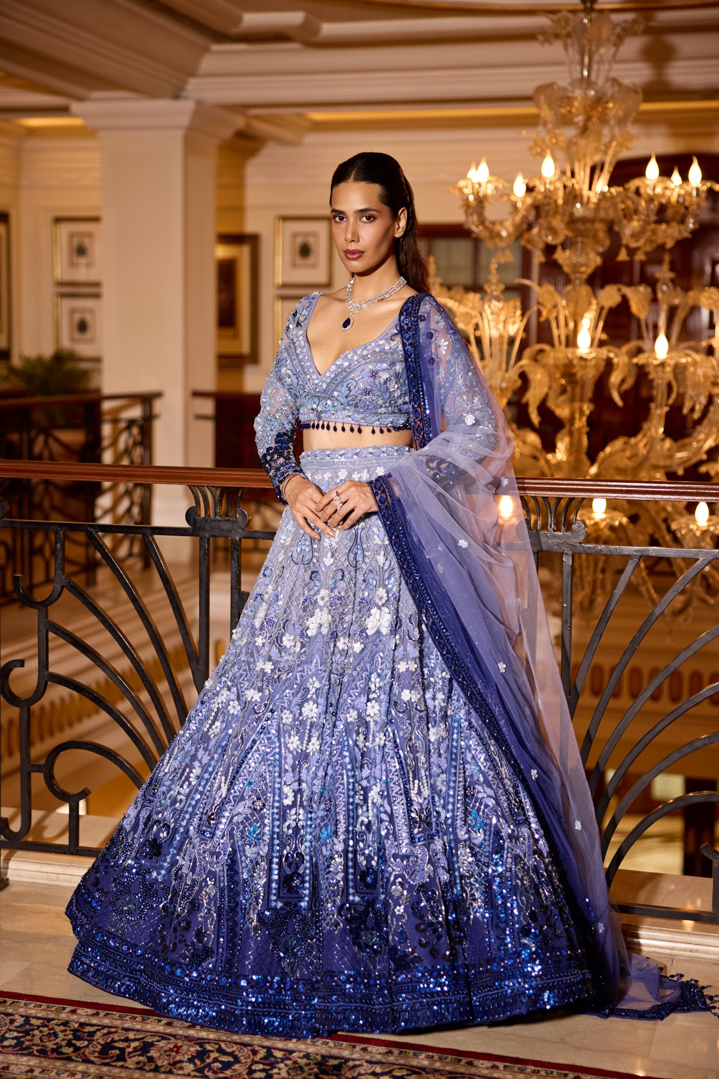 Modern bridal lehenga in royal blue ombre with opulent hand embroidery and crystal accents