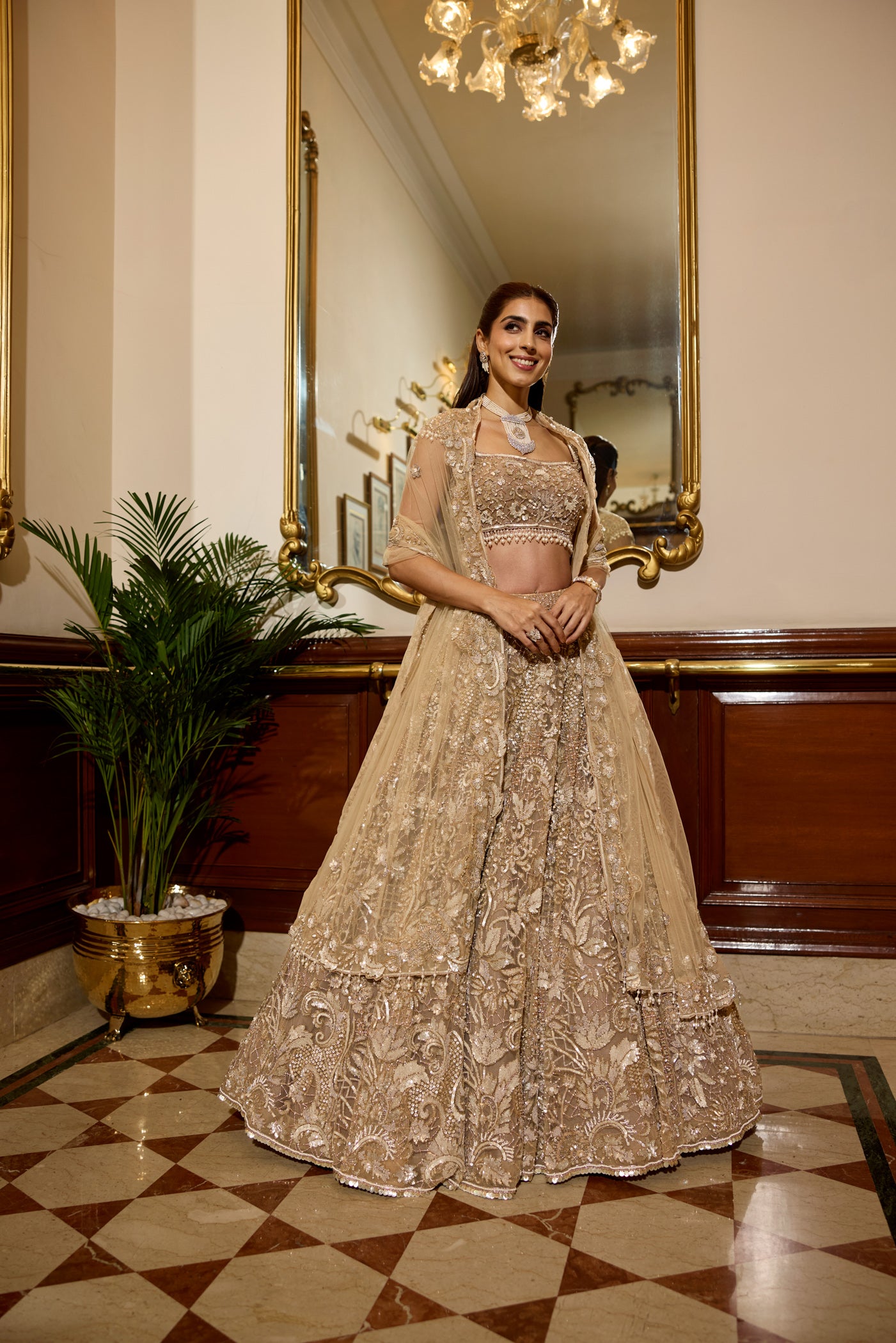 Modern intricate light gold hand work embroidery lehenga with crystal details perfect for a wedding engagement or sangeet function