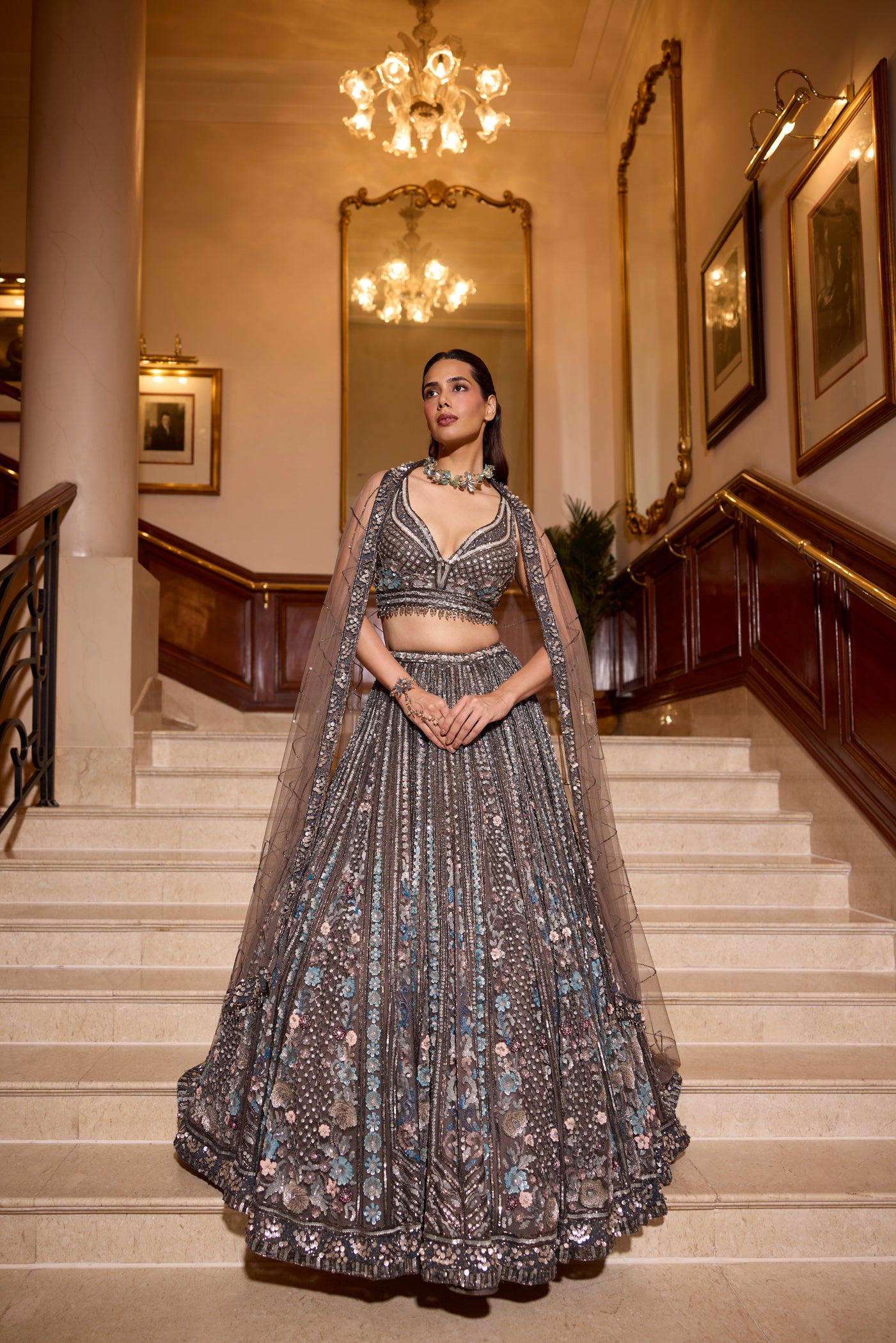Model wearing a grey silver sequin lehenga with floral embroidery and sheer dupatta – Opus Atelier bridal couture.