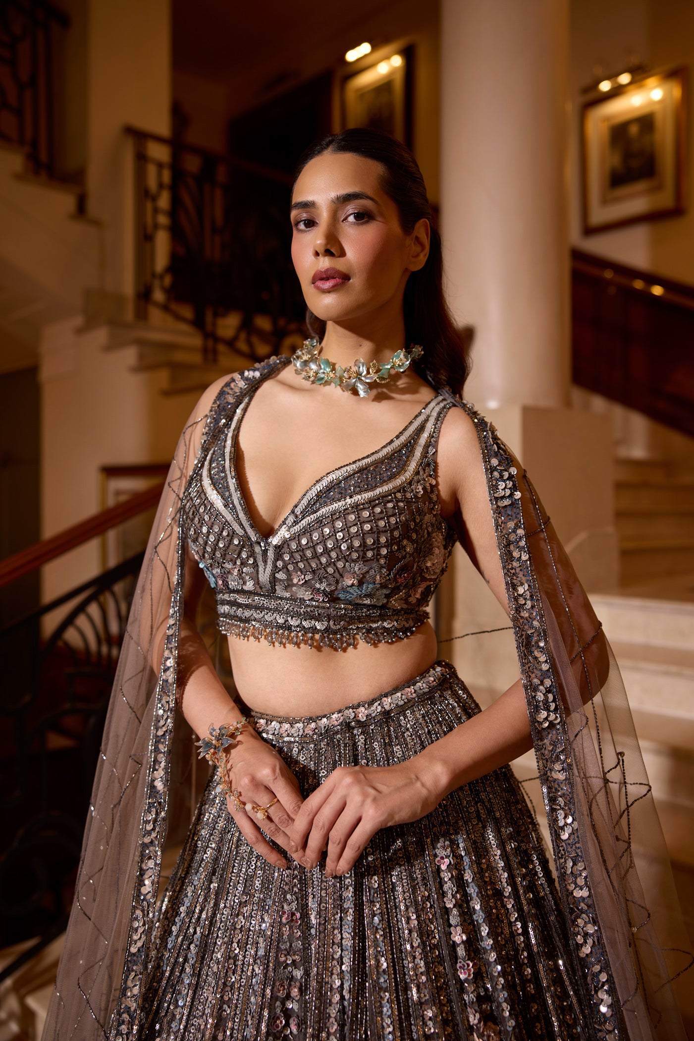 Elegant sequin lehenga in grey tones with pastel floral accents, designed for weddings and cocktail nights