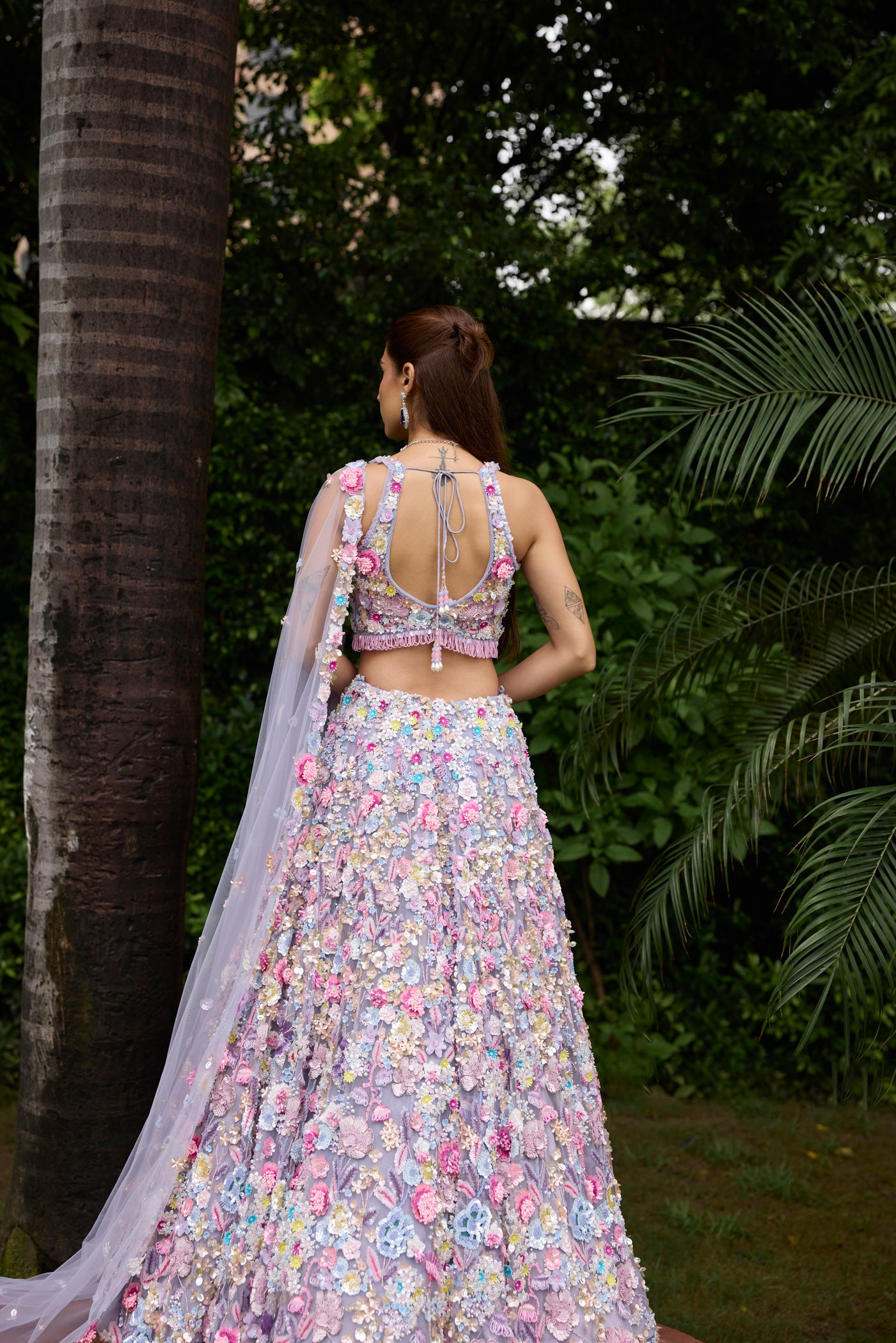 Modern bridal lehenga in pastel tones with flower embellishments and dupatta