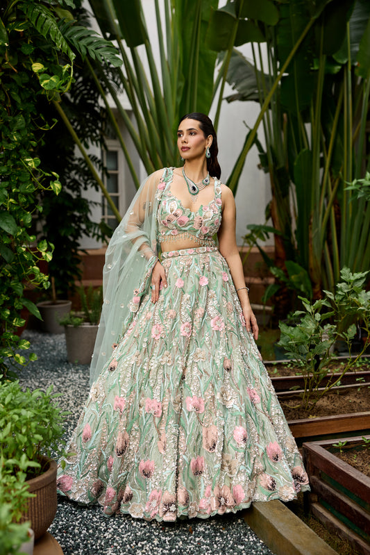 Pastel green floral embroidered lehenga with 3D multicolour flower motifs and detailed heavy dupatta by Opus Atelier