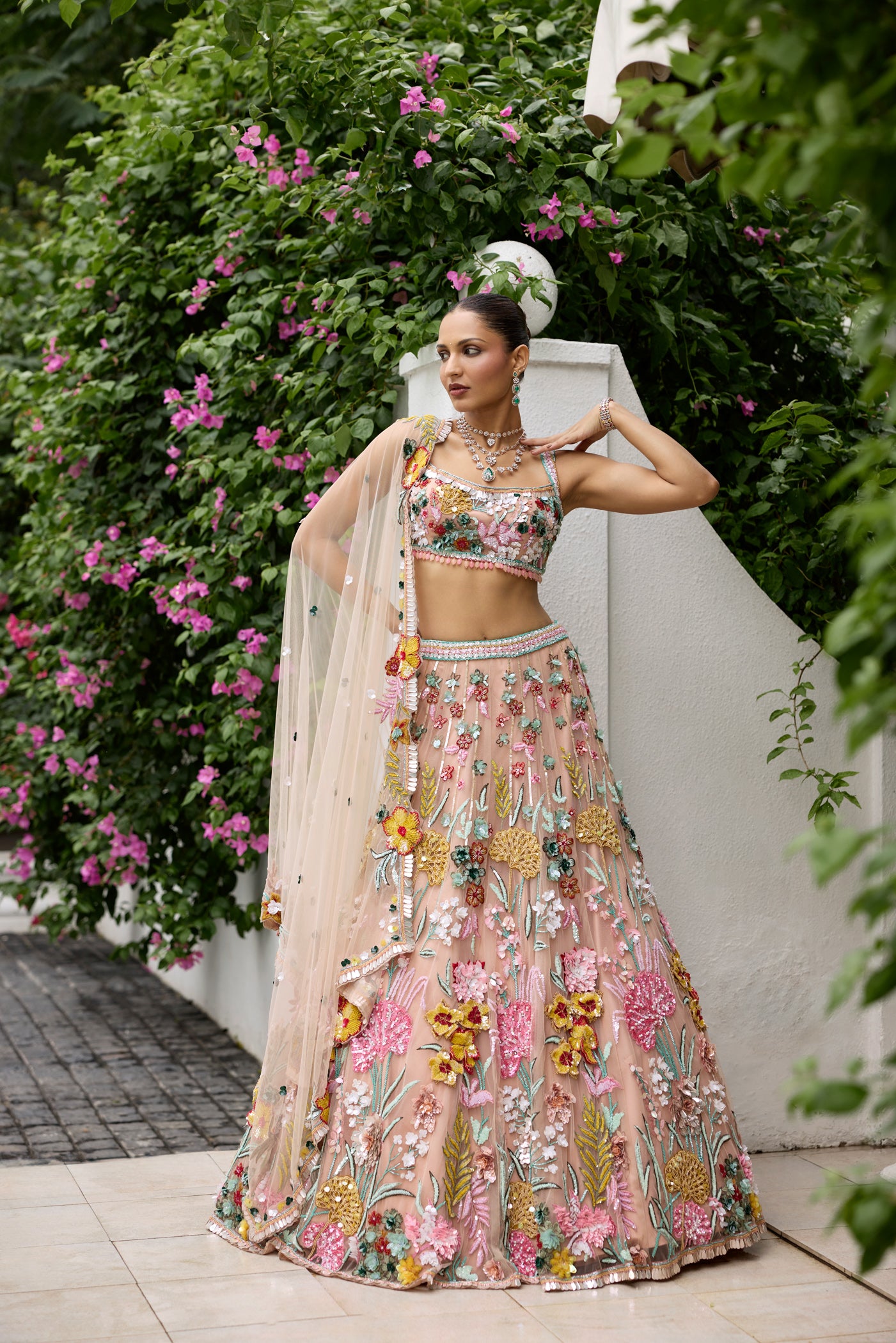 Modern bridal lehenga in peach tones with 3D floral motifs and applique work
