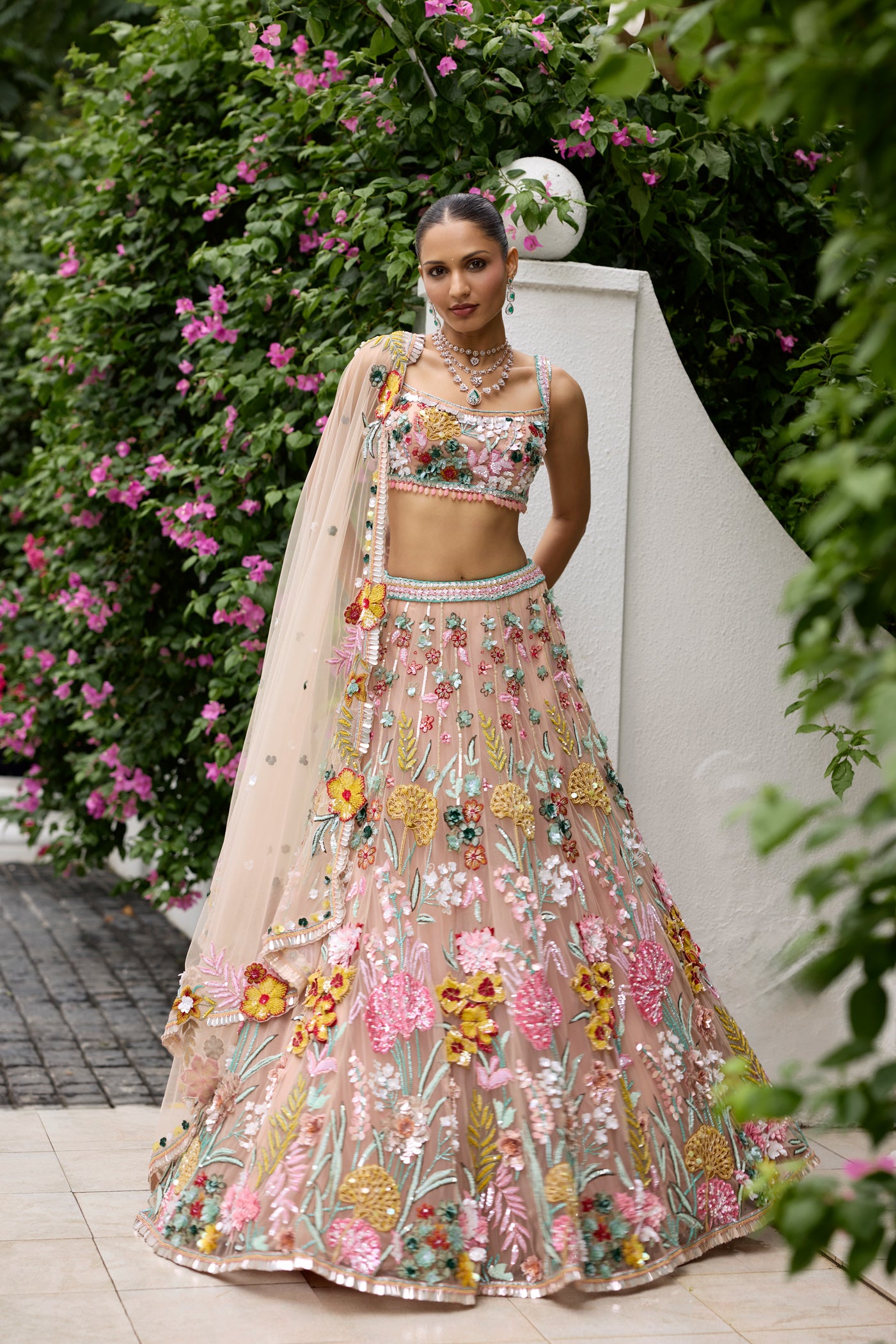 Peach pink lehenga with vibrant multicolour floral embroidery by Opus Atelier