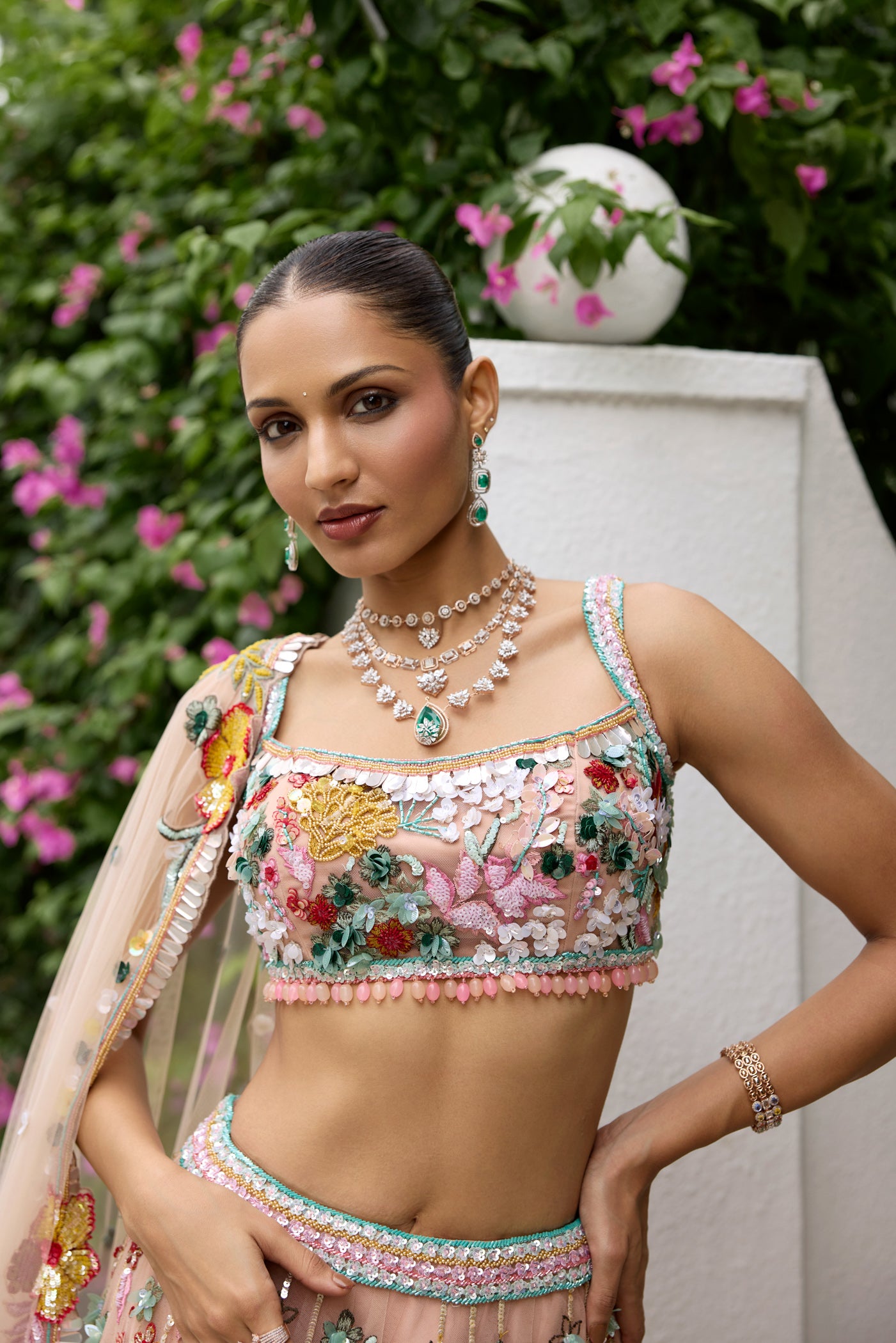 Peach pink lehenga with vibrant multicolour floral embroidery by Opus Atelier