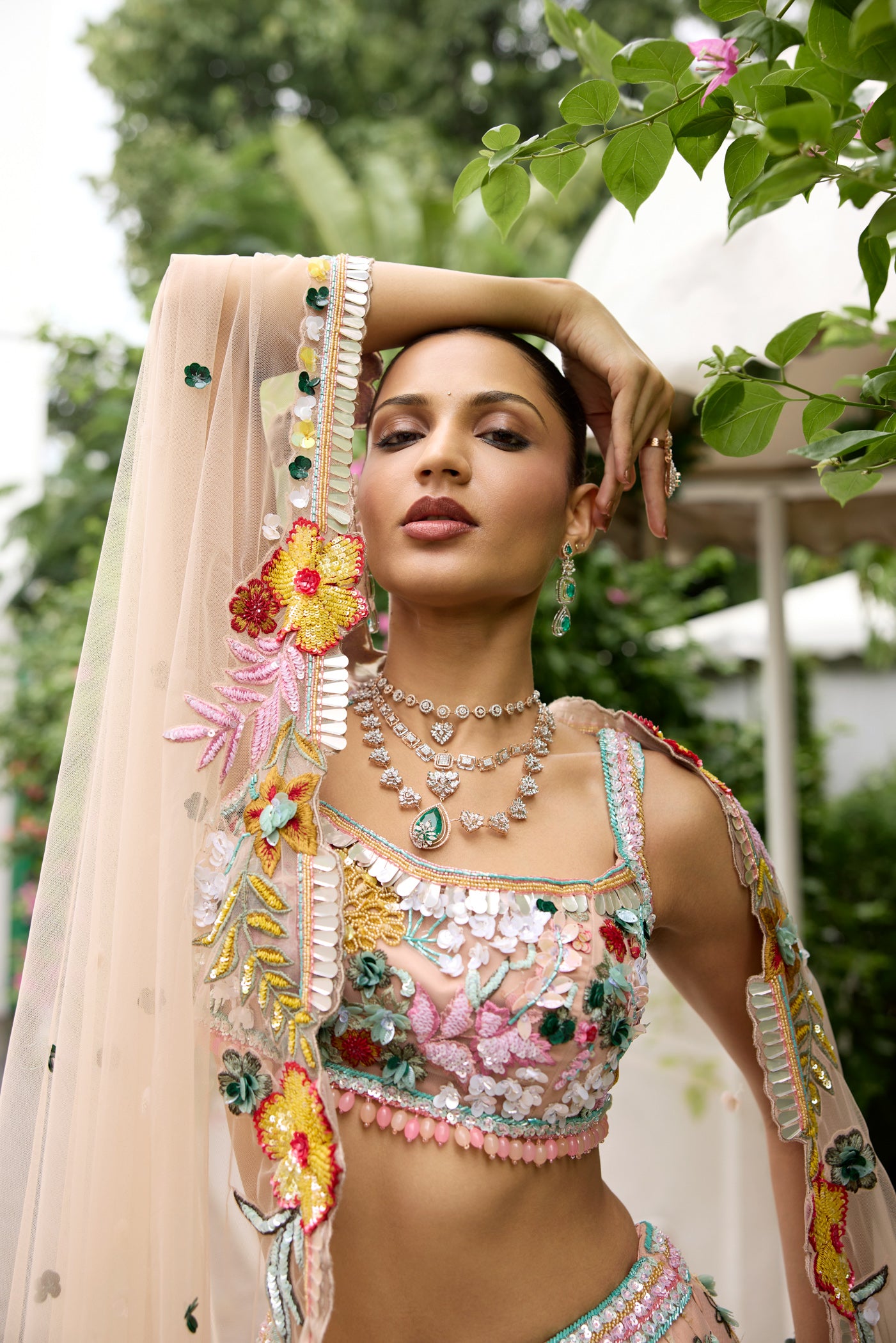 Peach pink lehenga with vibrant multicolour floral embroidery by Opus Atelier