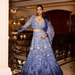 Model wearing blue ombre sequin bridal lehenga with 3D floral embroidery by Opus Atelier, paired with sheer dupatta