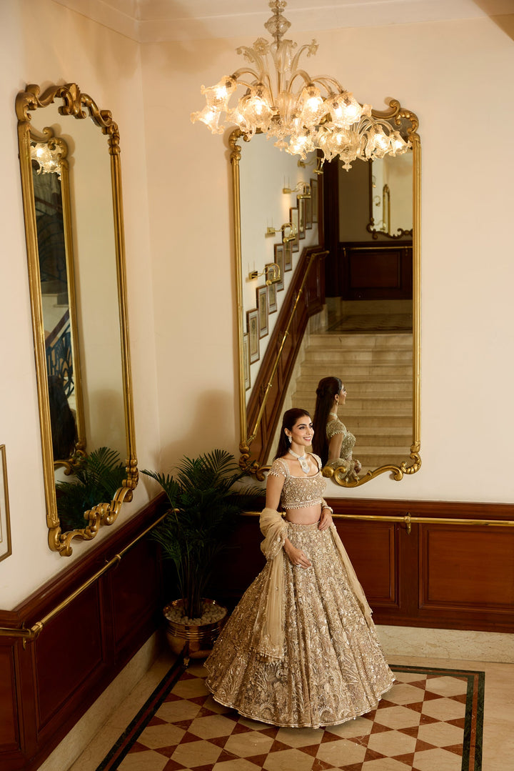 Golden wedding lehenga set with heavy embroidery and couture craftsmanship in a victorian era hotel by opus atelier