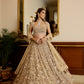 Champagne gold hand-embroidered bridal lehenga with intricate floral motifs and sheer dupatta by Opus Atelier