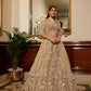 Modern intricate light gold hand work embroidery lehenga with crystal details perfect for a wedding engagement or sangeet function