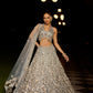 Grey silver to midnight blue ombré lehenga set with intricate zari and sequin embroidery, paired with blouse and dupatta by Opus Atelier, ideal for bridal receptions and evening cocktails