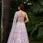 Modern bridal lehenga in pastel tones with flower embellishments and dupatta