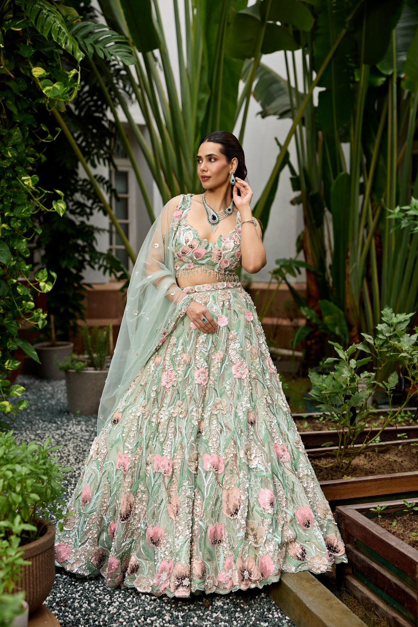 Pastel green floral embroidered lehenga with 3D multicolour flower motifs and detailed heavy dupatta by Opus Atelier