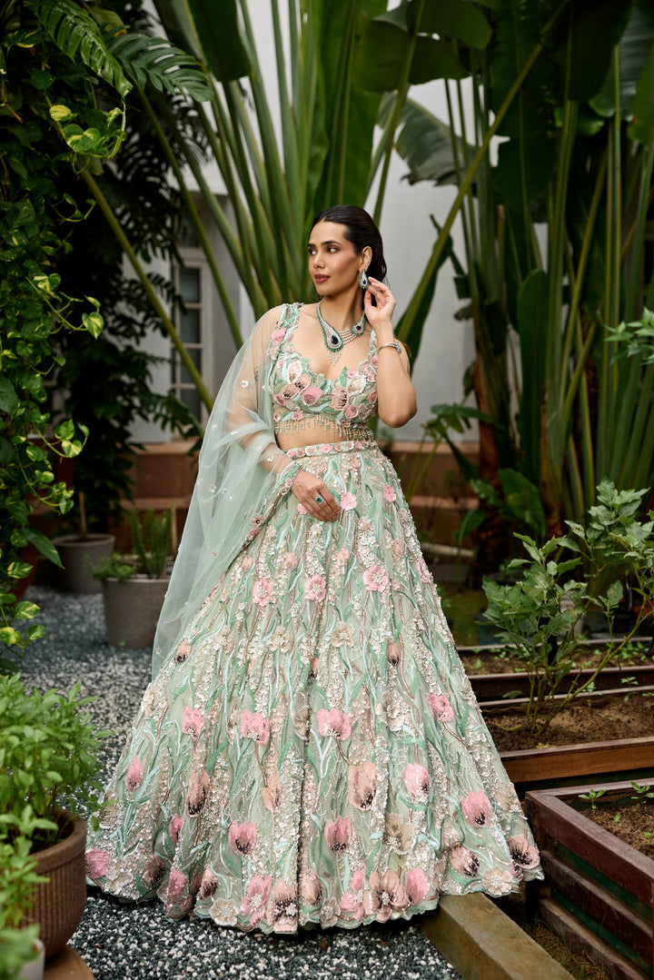 Pastel green floral embroidered lehenga with 3D multicolour flower motifs and detailed heavy dupatta by Opus Atelier