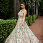 Luxury bridal lehenga in pastel green with intricate pink and beige floral embroidery