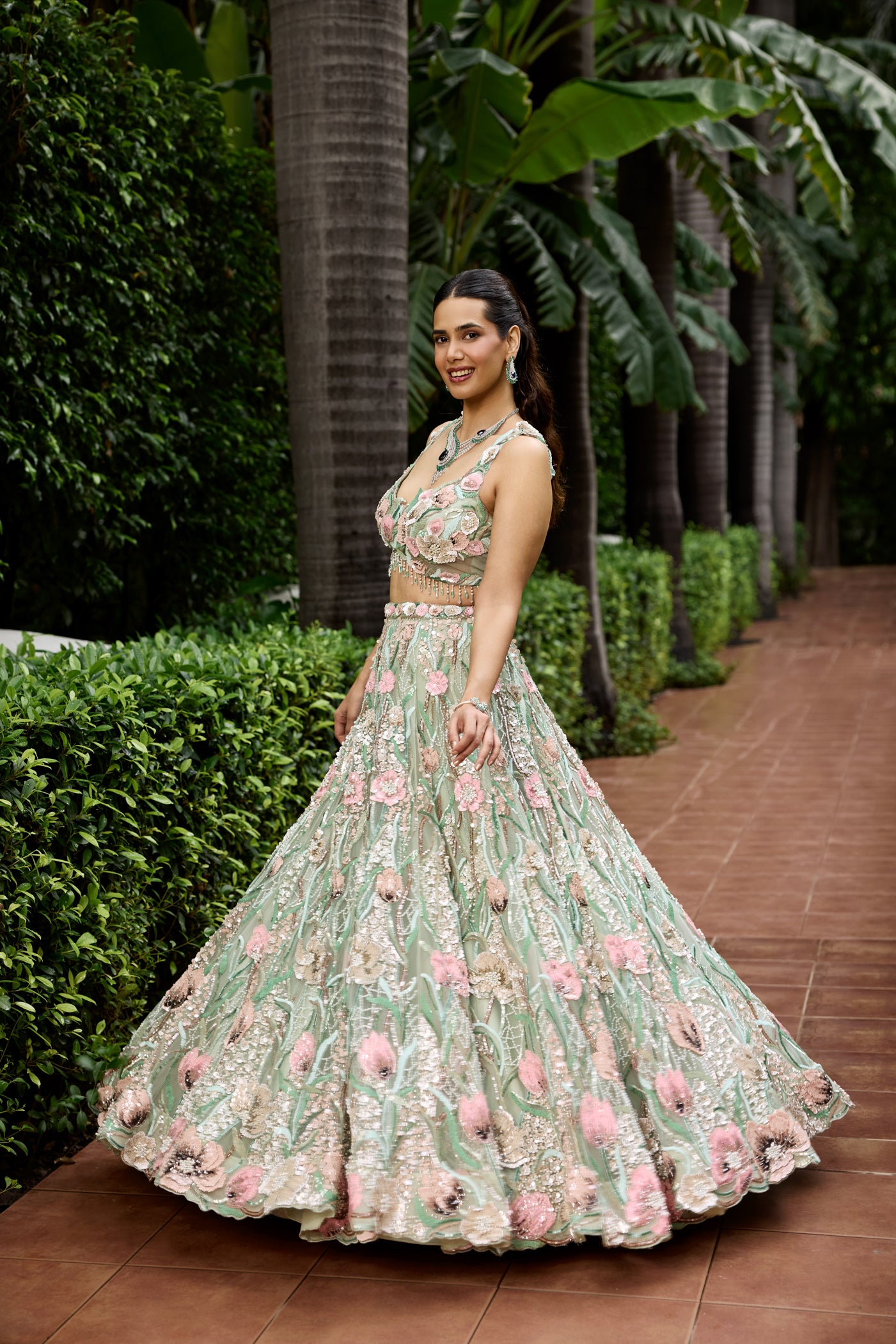 Luxury bridal lehenga in pastel green with intricate pink and beige floral embroidery