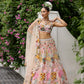 Modern bridal lehenga in peach tones with 3D floral motifs and applique work