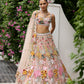 Peach pink lehenga with vibrant multicolour floral embroidery by Opus Atelier
