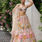 Peach pink lehenga with vibrant multicolour floral embroidery by Opus Atelier