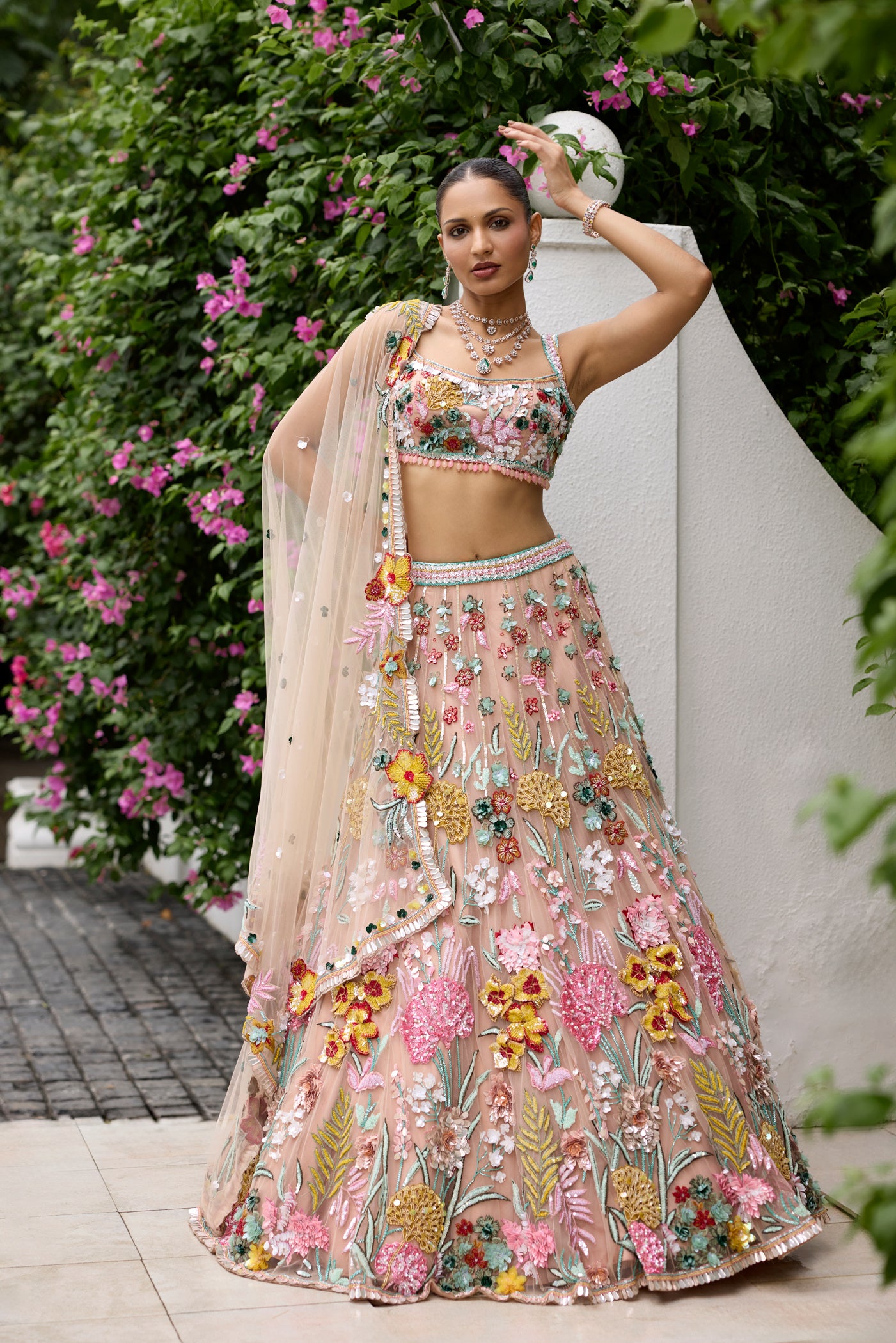 Peach pink lehenga with vibrant multicolour floral embroidery by Opus Atelier