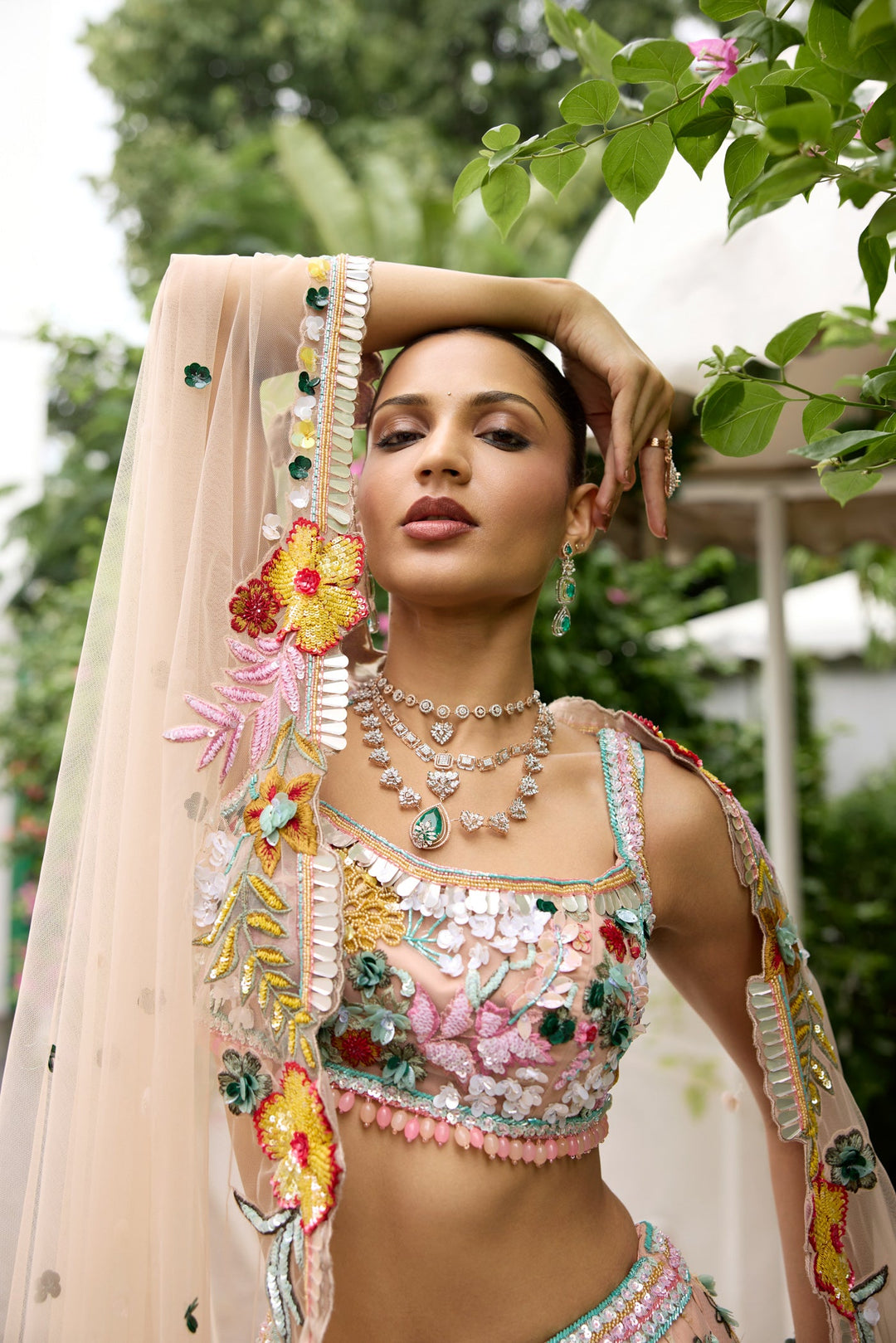 Peach pink lehenga with vibrant multicolour floral embroidery by Opus Atelier
