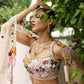 Peach pink lehenga with vibrant multicolour floral embroidery by Opus Atelier